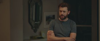 Movie still from “Robots” (2023), directed by Casper Christensen – A man with his arms crossed in front of a mirror; Medium shot, Over the shoulder angle