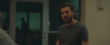 Movie still from “Robots” (2023), directed by Casper Christensen – A man standing in a room with his eyes closed; Close Up shot, Over the shoulder angle