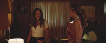 Movie still from “Robots” (2023), directed by Casper Christensen – Two women standing next to each other in front of a window; Medium shot, Over the shoulder angle