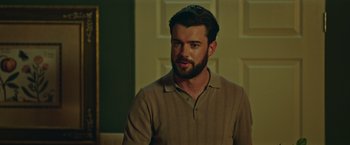 Movie still from “Robots” (2023), directed by Casper Christensen – A person with a beard; Close Up shot, Over the shoulder angle