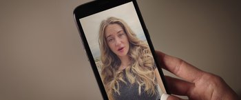 Movie still from “Robots” (2023), directed by Casper Christensen – A woman is taking a picture of herself on her phone; Close Up shot, Overhead angle