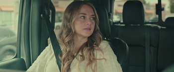 Movie still from “Robots” (2023), directed by Casper Christensen – A woman sitting in the back seat of a car; Close Up shot, Over the shoulder angle