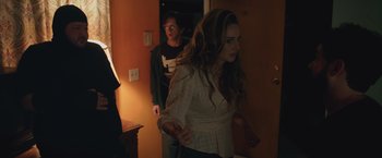 Movie still from “Robots” (2023), directed by Casper Christensen – A woman and a man are walking in a hallway; Medium shot, Over the shoulder angle