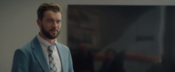 Movie still from “Robots” (2023), directed by Casper Christensen – A man wearing a suit and tie standing in front of a mirror; Close Up shot, Over the shoulder angle