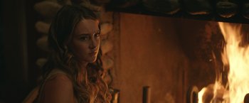 Movie still from “Robots” (2023), directed by Casper Christensen – A beautiful young woman with long red hair and green eyes; Close Up shot, Over the shoulder angle