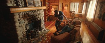 Movie still from “Robots” (2023), directed by Casper Christensen – A man and a woman are playing a video game; Wide shot, High angle