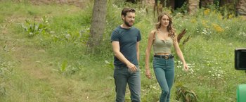 Movie still from “Robots” (2023), directed by Casper Christensen – A man and a woman are walking in the woods; Medium shot, Over the shoulder angle