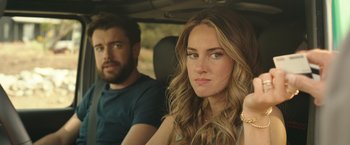 Movie still from “Robots” (2023), directed by Casper Christensen – A man and a woman sitting in the back of a car; Close Up shot, Over the shoulder angle