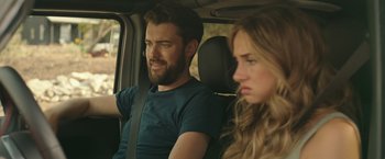 Movie still from “Robots” (2023), directed by Casper Christensen – A man and a woman sitting in the back seat of a car; Close Up shot, Over the shoulder angle