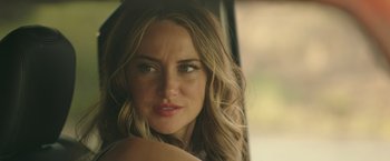 Movie still from “Robots” (2023), directed by Casper Christensen – A person with long hair; Close Up shot, Over the shoulder angle