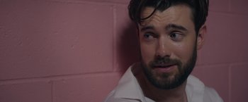 Movie still from “Robots” (2023), directed by Casper Christensen – A person wearing a white shirt; Close Up shot, Over the shoulder angle