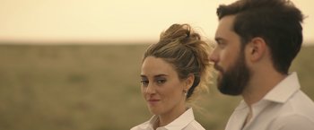 Movie still from “Robots” (2023), directed by Casper Christensen – A man and a woman standing next to each other in a field; Close Up shot, Over the shoulder angle