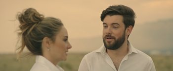 Movie still from “Robots” (2023), directed by Casper Christensen – A man and a woman talking to each other outside; Close Up shot, Over the shoulder angle