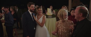 Movie still from “Robots” (2023), directed by Casper Christensen – A man and a woman standing next to each other at an event; Medium shot, Over the shoulder angle