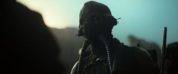 Movie still from “Rogue One: A Star Wars Story” (2016), directed by Gareth Edwards – A man with a gas mask on is looking at the camera; Close Up shot, Low angle