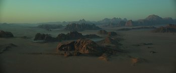 Movie still from “Rogue One: A Star Wars Story” (2016), directed by Gareth Edwards – An image of a desert scene with mountains in the background; Extreme Wide shot, High angle