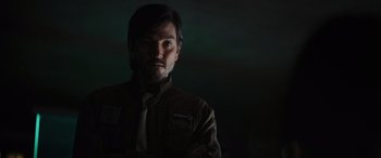 Movie still from “Rogue One: A Star Wars Story” (2016), directed by Gareth Edwards – A man in a brown jacket and a white tie; Close Up shot, Low angle