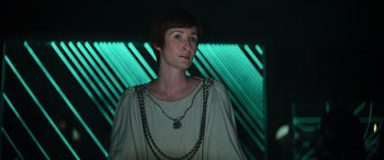 Movie still from “Rogue One: A Star Wars Story” (2016), directed by Gareth Edwards – A woman wearing a chain around her neck; Close Up shot, Low angle