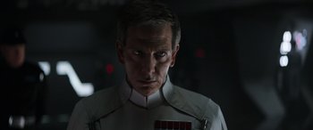 Movie still from “Rogue One: A Star Wars Story” (2016), directed by Gareth Edwards – A person wearing a uniform; Close Up shot, Over the shoulder angle