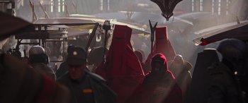 Movie still from “Rogue One: A Star Wars Story” (2016), directed by Gareth Edwards – A group of people in red robes and black hoods; Wide shot, High angle