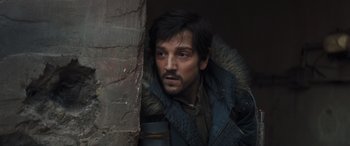 Movie still from “Rogue One: A Star Wars Story” (2016), directed by Gareth Edwards – A person wearing a jacket; Close Up shot, Over the shoulder angle