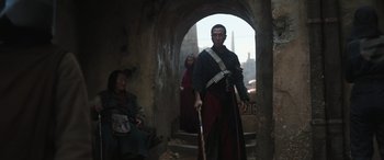 Movie still from “Rogue One: A Star Wars Story” (2016), directed by Gareth Edwards – A man with a cane standing next to a woman; Medium shot, Low angle