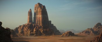 Movie still from “Rogue One: A Star Wars Story” (2016), directed by Gareth Edwards – A large rock formation in the middle of the desert; Extreme Wide shot, Low angle