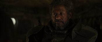 Movie still from “Rogue One: A Star Wars Story” (2016), directed by Gareth Edwards – A person wearing a helmet; Close Up shot, Over the shoulder angle