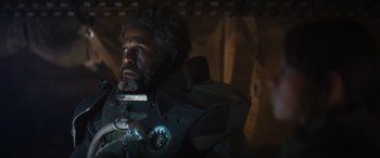 Movie still from “Rogue One: A Star Wars Story” (2016), directed by Gareth Edwards – A man with a beard is wearing a helmet; Close Up shot, Low angle
