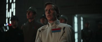 Movie still from “Rogue One: A Star Wars Story” (2016), directed by Gareth Edwards – A person wearing a uniform; Close Up shot, Low angle