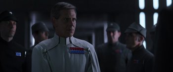 Movie still from “Rogue One: A Star Wars Story” (2016), directed by Gareth Edwards – A man in a uniform standing next to another man; Close Up shot, Over the shoulder angle