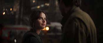 Movie still from “Rogue One: A Star Wars Story” (2016), directed by Gareth Edwards – A young woman looking at a man in the dark; Close Up shot, Over the shoulder angle