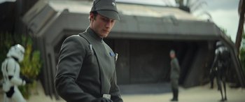 Movie still from “Rogue One: A Star Wars Story” (2016), directed by Gareth Edwards – A man wearing a uniform and a hat; Medium shot, Low angle