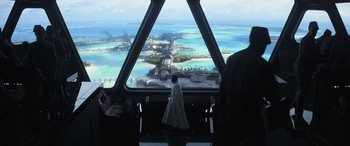 Movie still from “Rogue One: A Star Wars Story” (2016), directed by Gareth Edwards – A person standing in front of a window looking out at the ocean; Extreme Wide shot, Over the shoulder angle