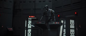 Movie still from “Rogue One: A Star Wars Story” (2016), directed by Gareth Edwards – A man standing on top of a platform; Wide shot, Low angle