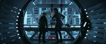 Movie still from “Rogue One: A Star Wars Story” (2016), directed by Gareth Edwards – A couple of people standing next to each other in a room; Medium shot, Low angle