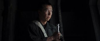 Movie still from “Rogue One: A Star Wars Story” (2016), directed by Gareth Edwards – A man holding a flashlight in a dark room; Close Up shot, Low angle