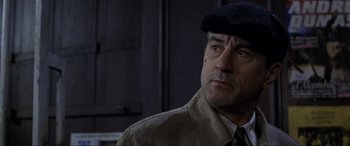 Movie still from “Ronin” (1998), directed by John Frankenheimer – A person wearing a hat; Close Up shot, Low angle