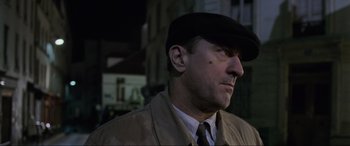 Movie still from “Ronin” (1998), directed by John Frankenheimer – A person wearing a hat; Close Up shot, Low angle