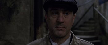 Movie still from “Ronin” (1998), directed by John Frankenheimer – A person wearing a hat; Close Up shot, Low angle