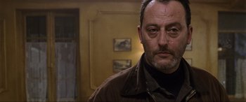 Movie still from “Ronin” (1998), directed by John Frankenheimer – A person wearing a brown jacket; Close Up shot, Low angle