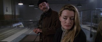 Movie still from “Ronin” (1998), directed by John Frankenheimer – A man and a woman standing next to each other; Close Up shot, Over the shoulder angle