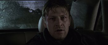 Movie still from “Ronin” (1998), directed by John Frankenheimer – A person in a car; Close Up shot, Low angle