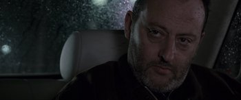 Movie still from “Ronin” (1998), directed by John Frankenheimer – A person sitting in a car; Close Up shot, Low angle