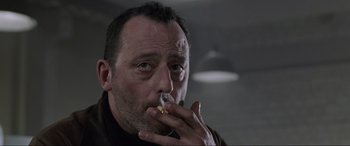Movie still from “Ronin” (1998), directed by John Frankenheimer – A person with a cigarette in his mouth; Close Up shot, Low angle