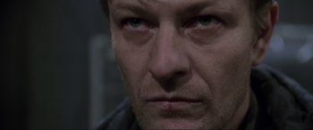 Movie still from “Ronin” (1998), directed by John Frankenheimer – A man's eyes and face; Close Up shot, Low angle