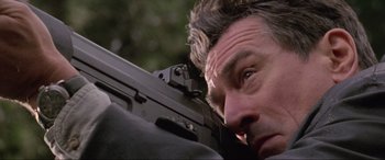 Movie still from “Ronin” (1998), directed by John Frankenheimer – A person with a gun; Close Up shot, Low angle