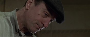 Movie still from “Ronin” (1998), directed by John Frankenheimer – A person wearing a hat; Close Up shot, Low angle