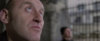 Movie still from “Ronin” (1998), directed by John Frankenheimer – A man's eyes and face; Close Up shot, Low angle