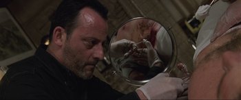 Movie still from “Ronin” (1998), directed by John Frankenheimer – A man looking into a mirror with blood on his face; Close Up shot, Over the shoulder angle